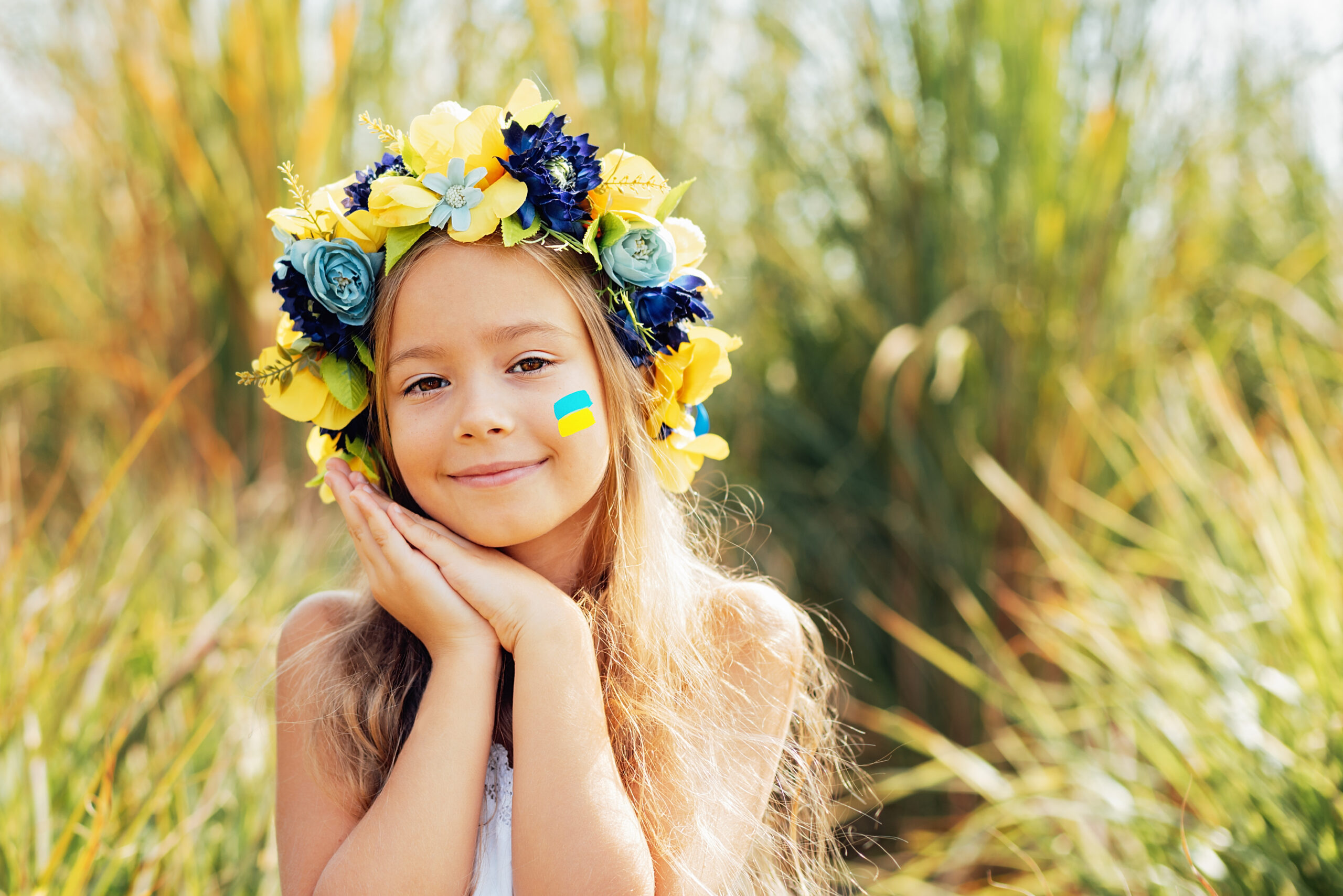 Ukrainian child girl with yellow and blue flag of Ukraine